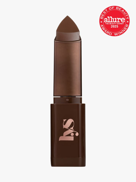 LYS Beauty Triple Fix Blurring Skin Tint Foundation Stick in branded dark brown twist up component on light gray background with red Allure Best of Beauty seal in the top right corner